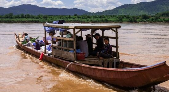 Panoramic view of Pak Beng’s serene river for a scenic Pak Beng Tours banner by Legend Travel Group.